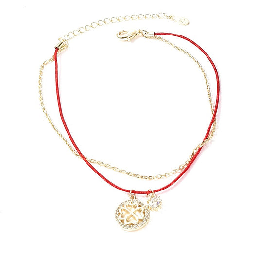 Soft bracelet with red nylon thread clover charms