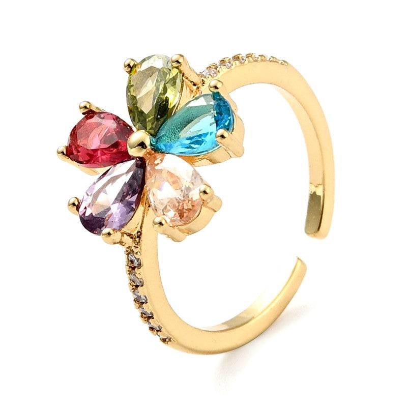 Anillo de mujer ajustable con flores de circonitas engastadas en diferentes colores.